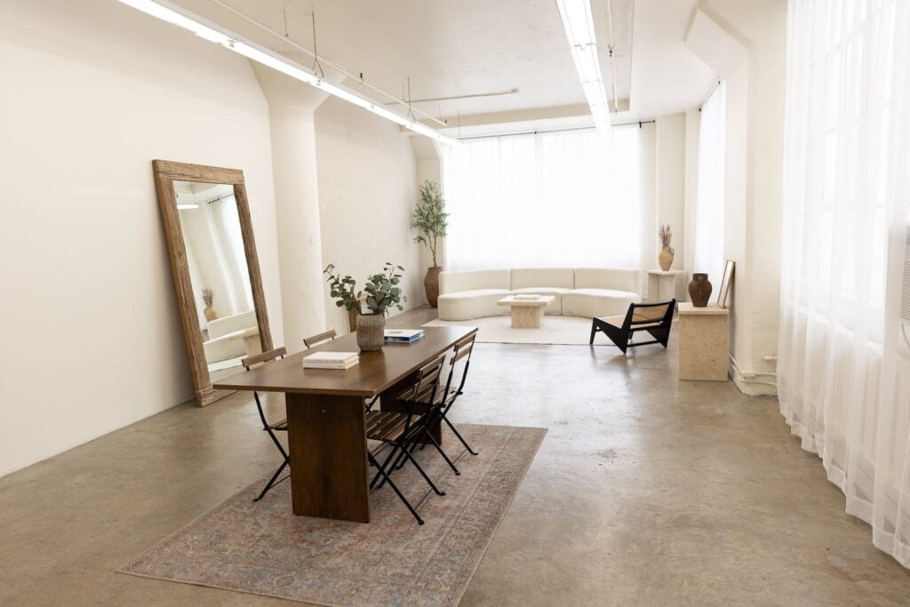A living and dining room set up at a bright white LA studio