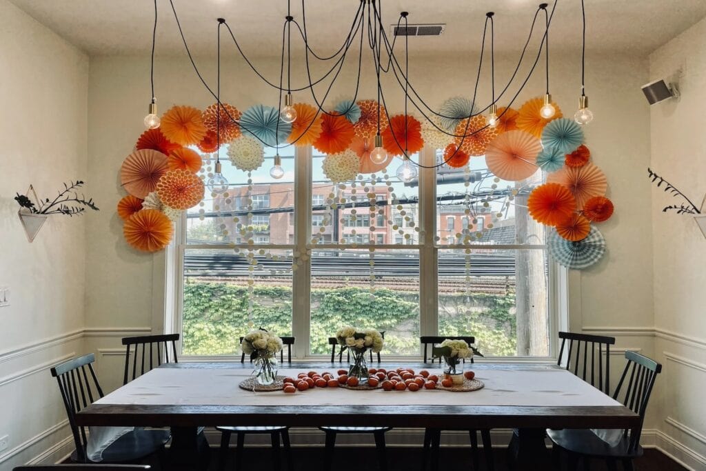 Brightly-colored pinwheels decorate a window inside a dining room
