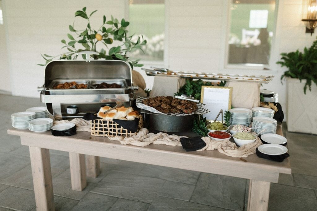 Small backyard wedding food ideas with different food and dishes on wood table