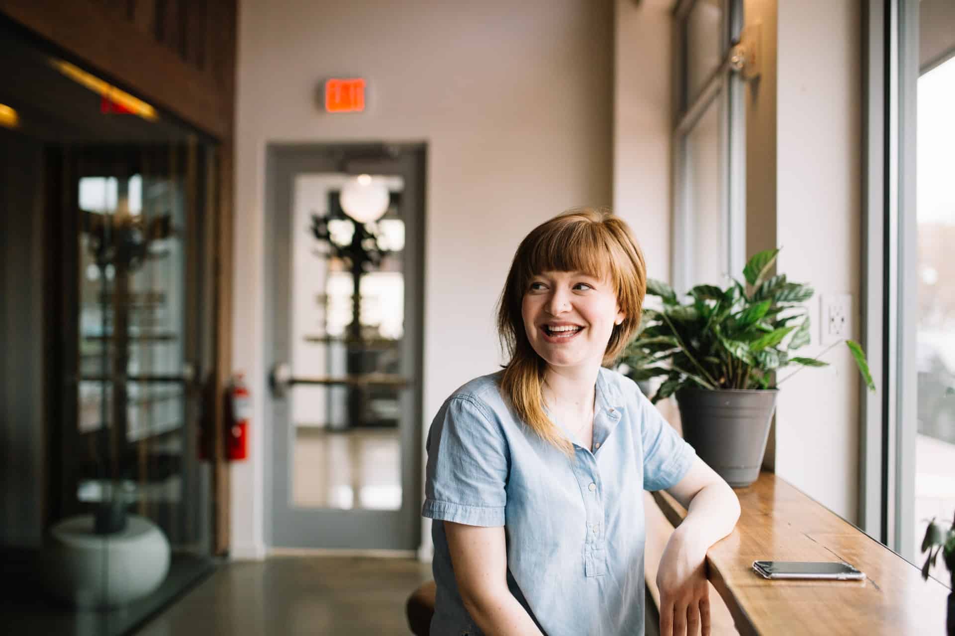 woman smiling by window