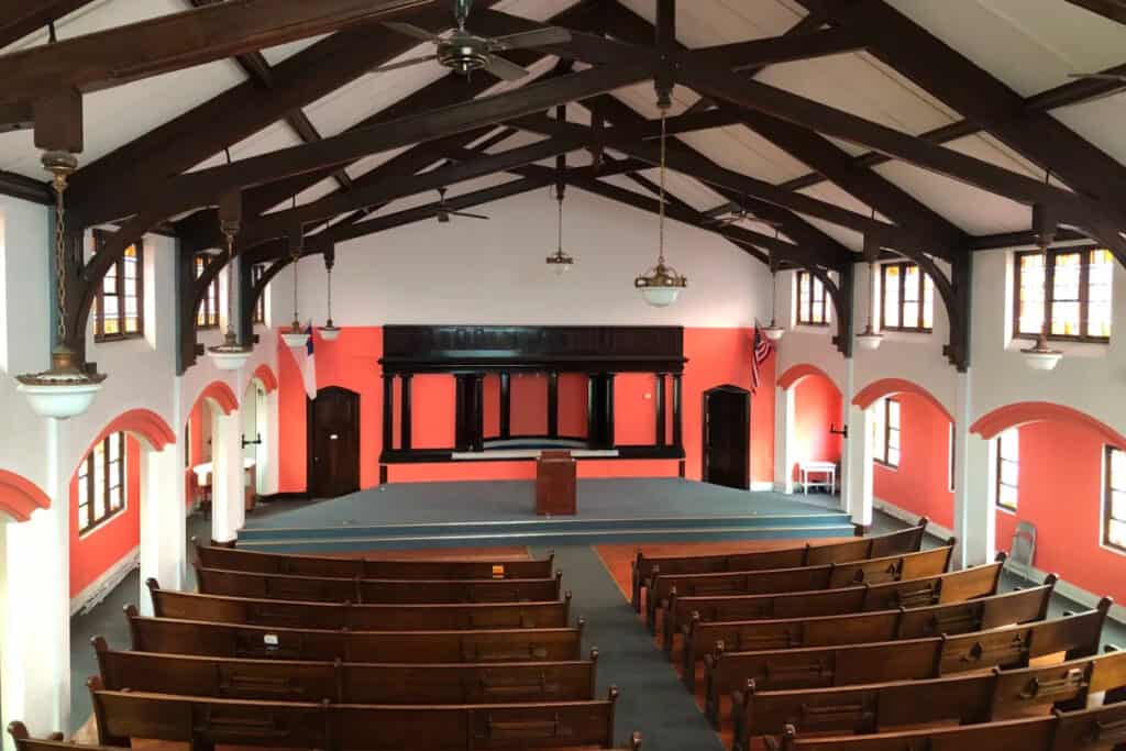 a historic church with peaked ceilings and wooden pews