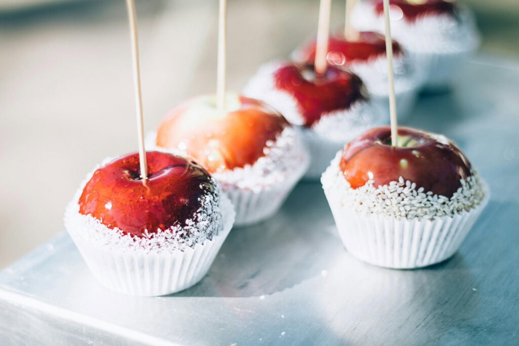 Caramel apples sit in muffin wrappers