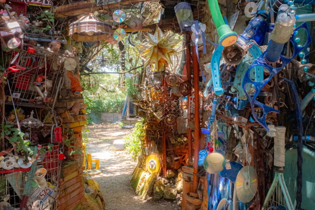 Junk lines the path to a clearing at the Cathedral of Junk in Austin