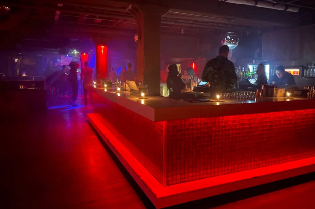 a night club with a red glowing bar