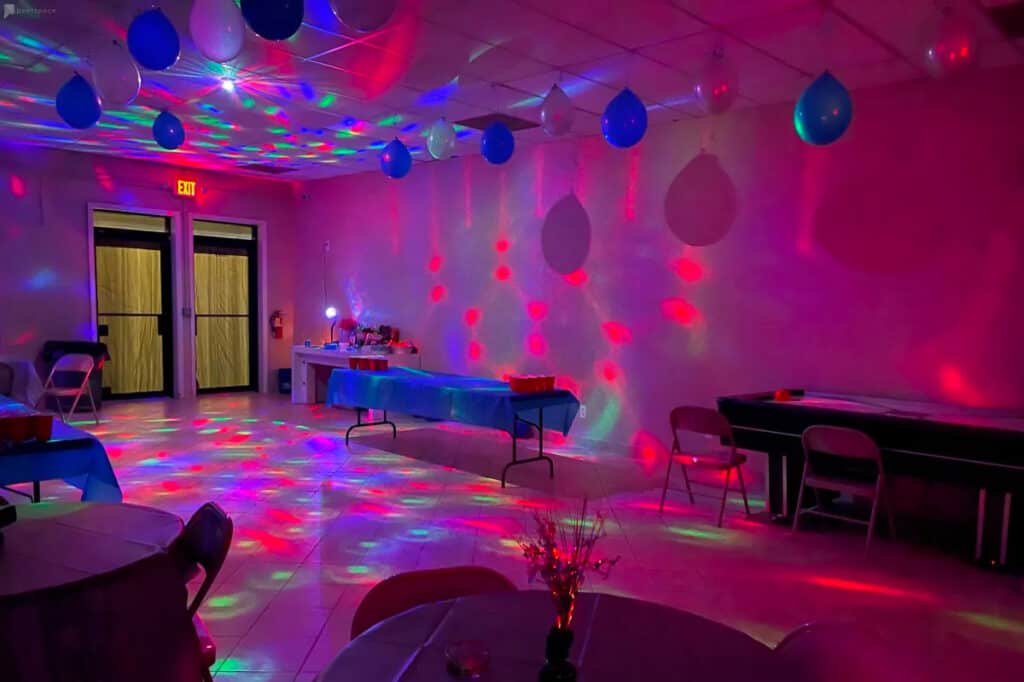 party venue with colorful lights and balloons