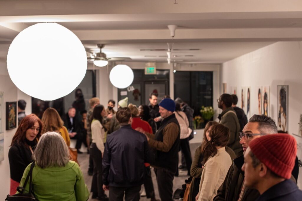 Crowded gallery-style networking reception for Atlanta corporate planners