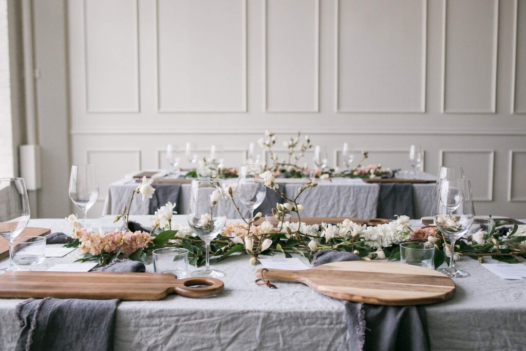 Table decorated by Atlanta corporate event planner with white linens and candles