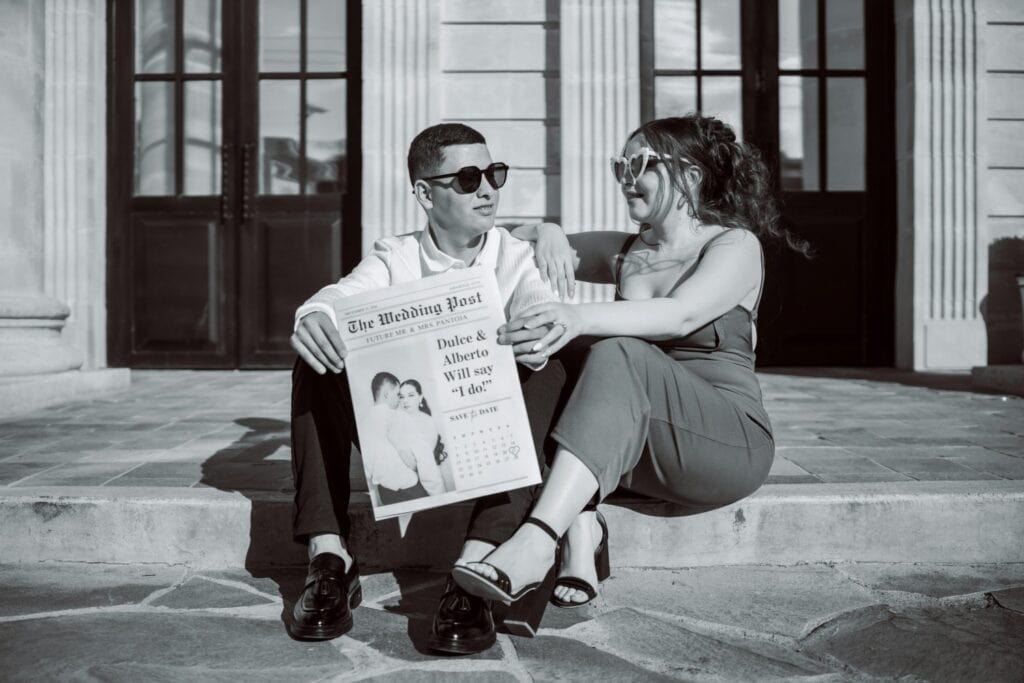 a couple holding their engagement announcement