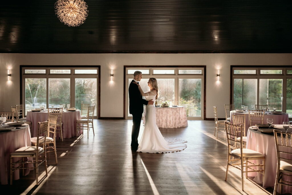 A bride and groom steal a private moment at their reception while nobody is around