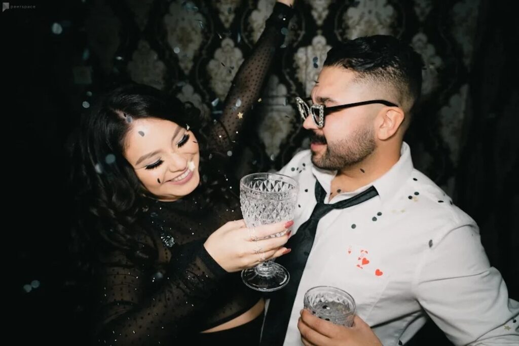 A couple celebrates with confetti falling around them