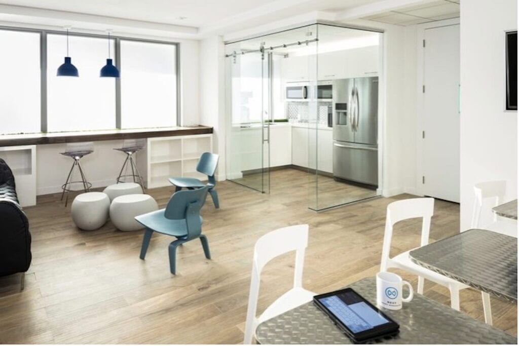 Bright, light-filled coworking space in Miami with a small kitchen and lots of windows