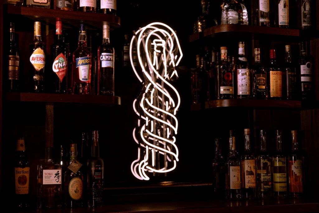 Neon sign of a snake hanging on a bar at Culebra in Chicago