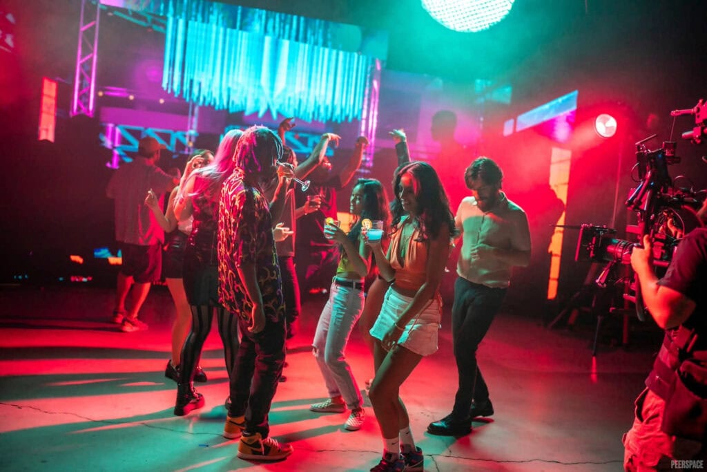 People dance on a dance floor for a film shoot