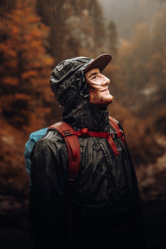 Man in raincoat standing in the rain