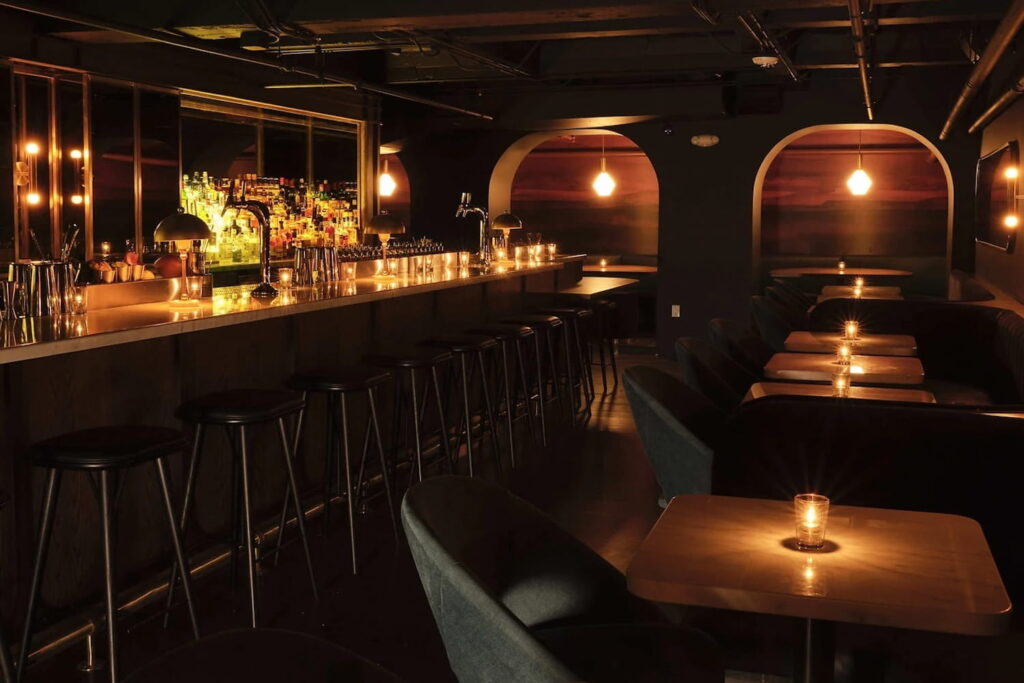 A dimly-lit bar and lounge area at a restaurant in LA
