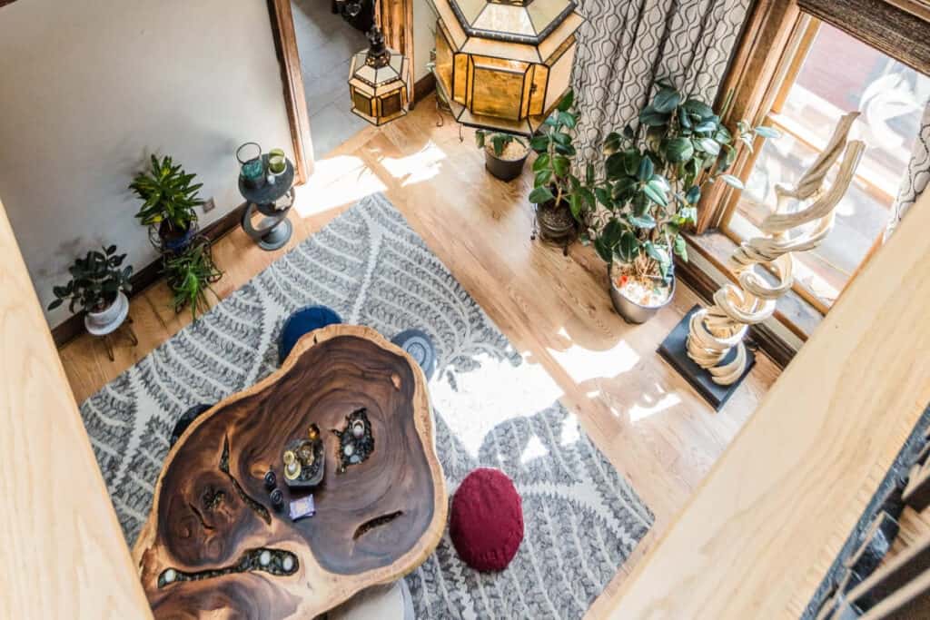 An aerial shot of a rustic space in Denver filled with wooden flooring, decor, and plants