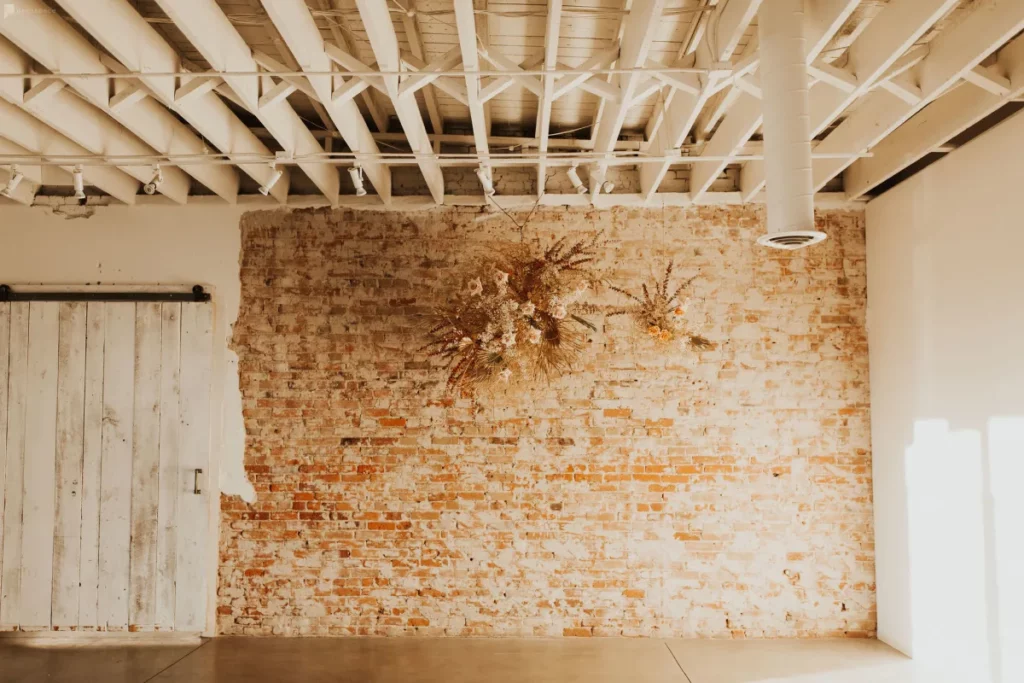 A rustic loft with an exposed brick wall in Denver