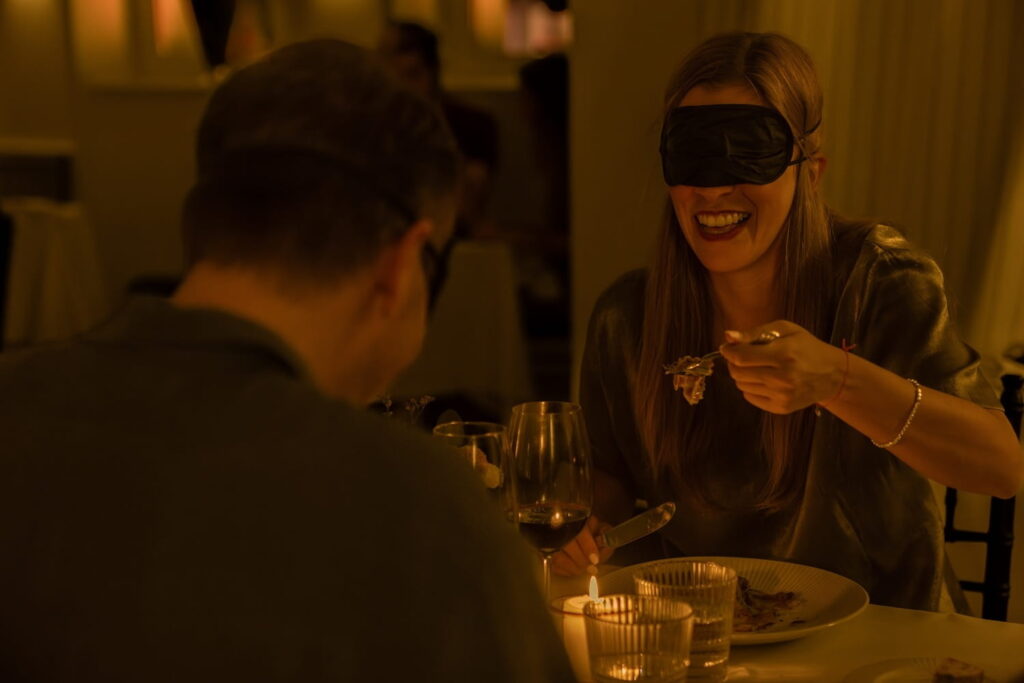 A man and woman dine blindfolded at a dining event in NYC