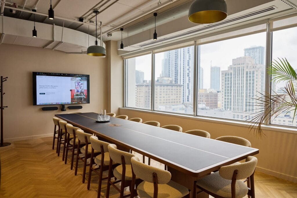 Neutrally decorated conference room in downtown Miami with windows overlooking the city