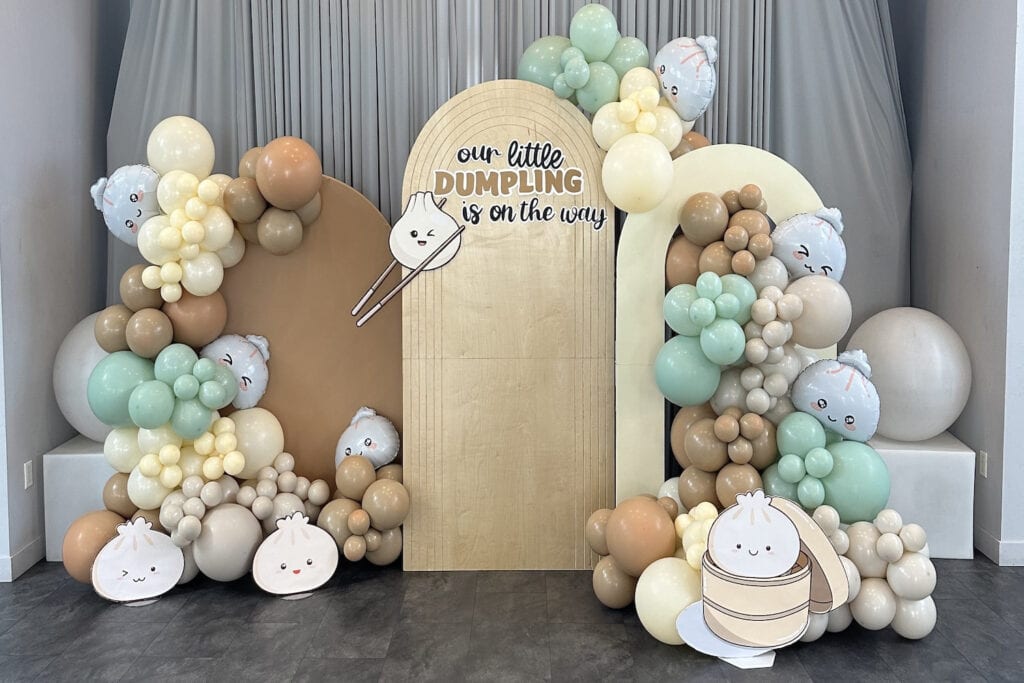 A dumpling-themed backdrop at a baby event