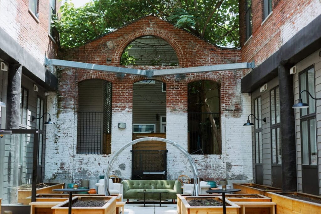 An eclectic garden area is set on a rustic, industrial rooftop in Philadelphia