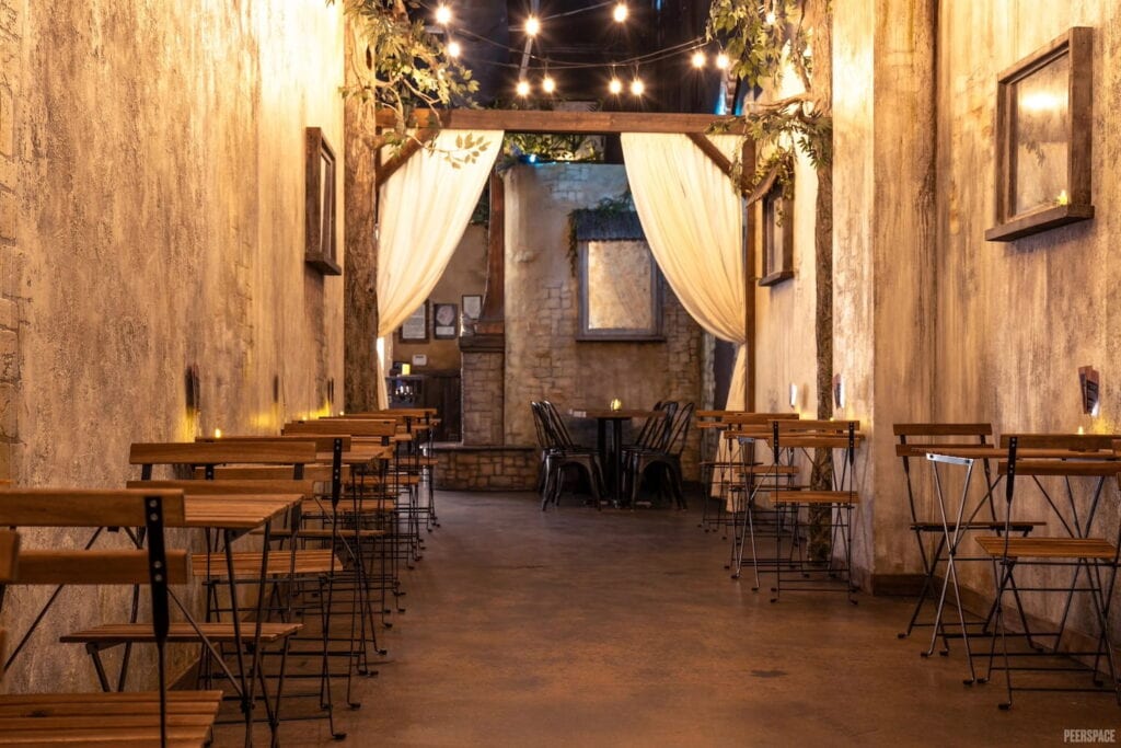 Stone alleyway with wooden accents and small tables provides a European vibe