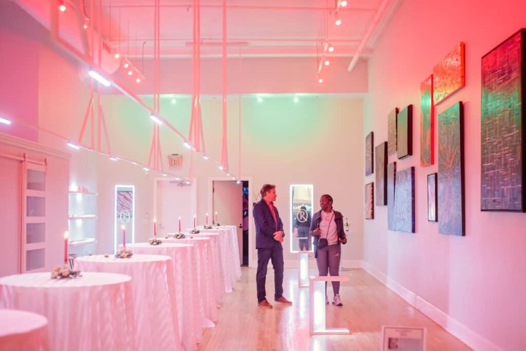 two people in a gallery with rbg lighting