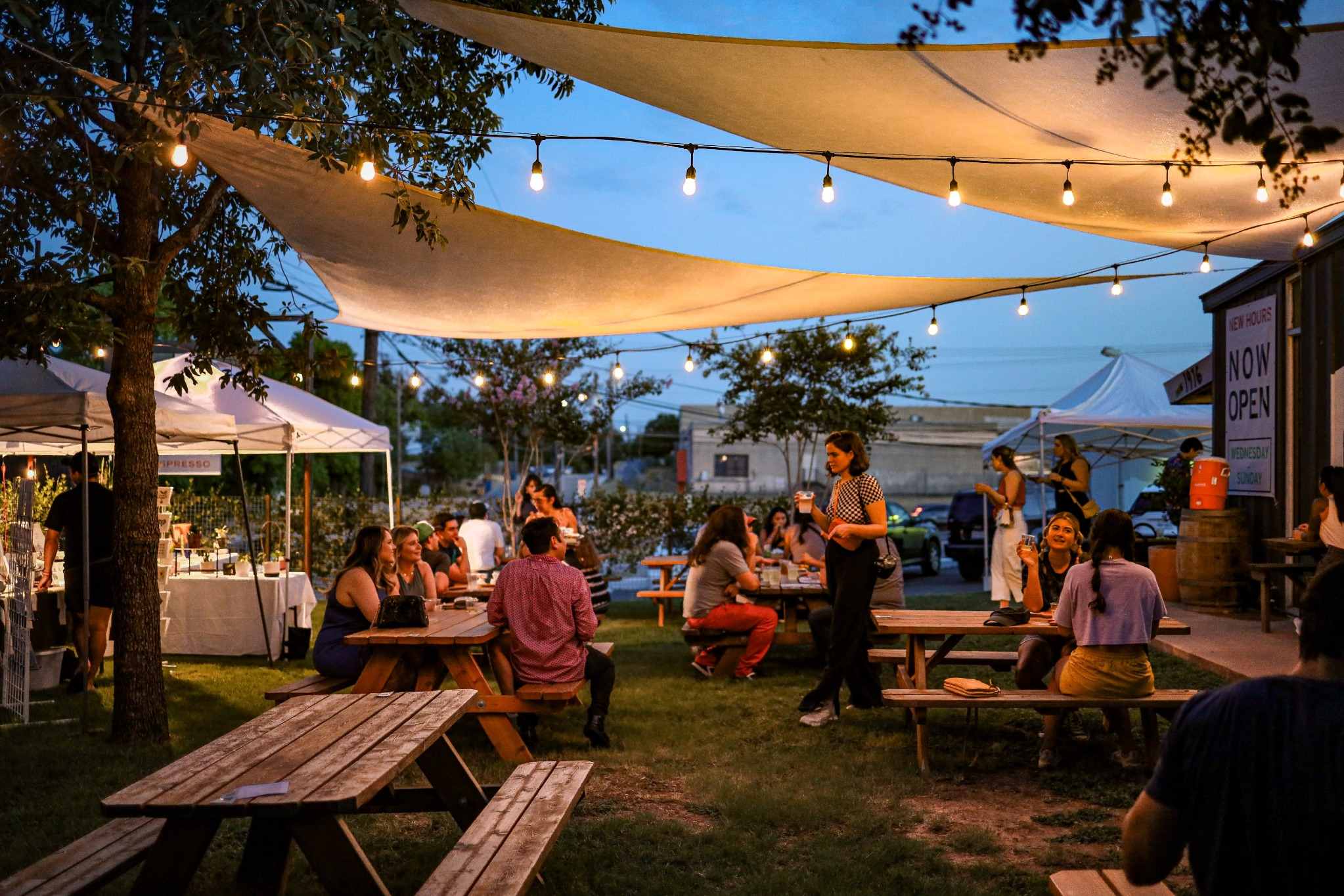 Lively Austin waterfront gathering with shade sails and string lights