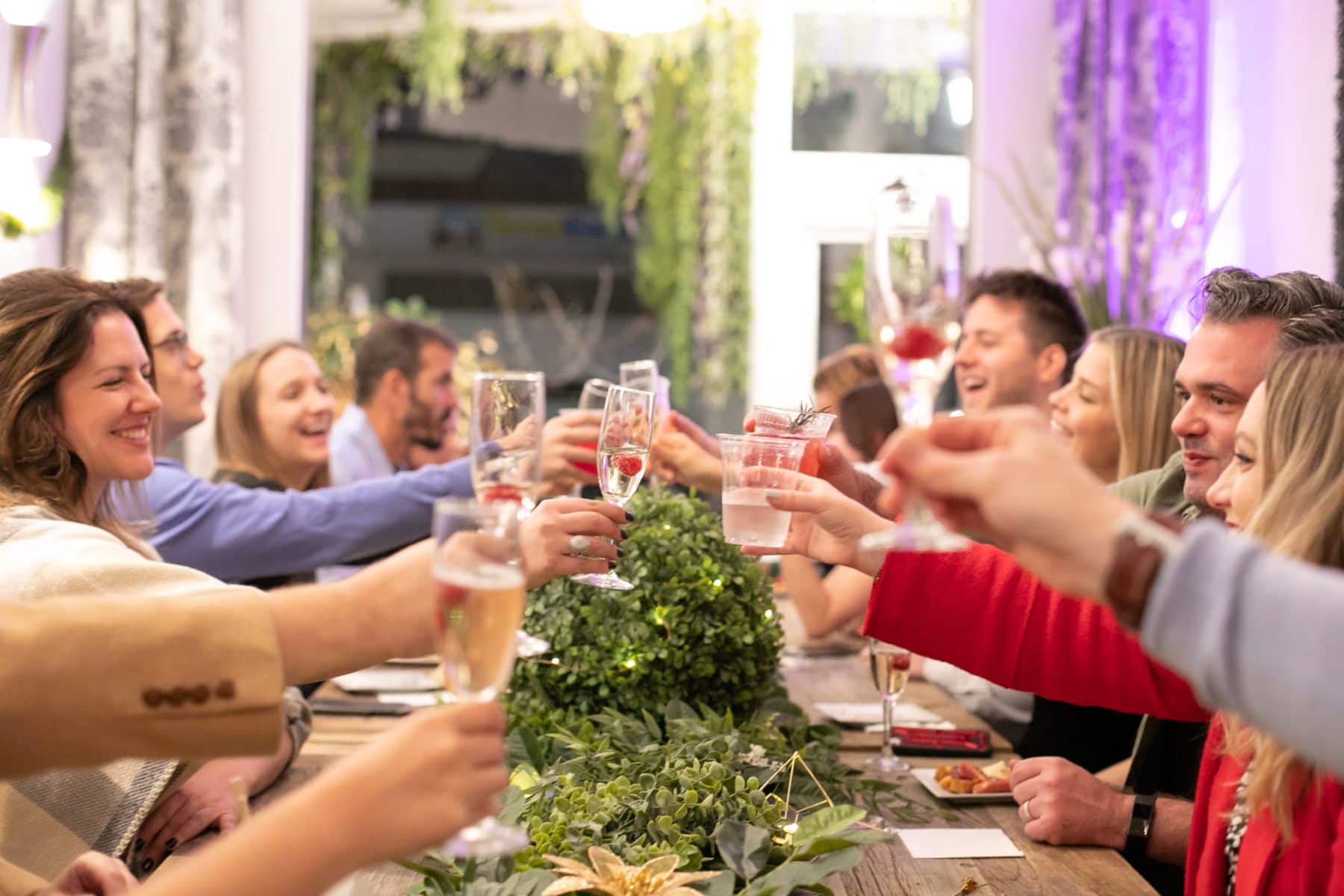 Guests toasting at a styled California celebration dinner table