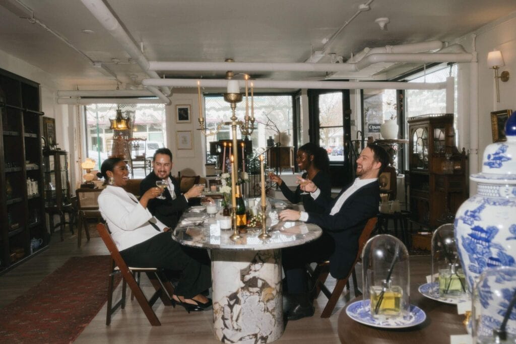 Four formally dressed people sitting at fancy marble table at event planned in Chicago