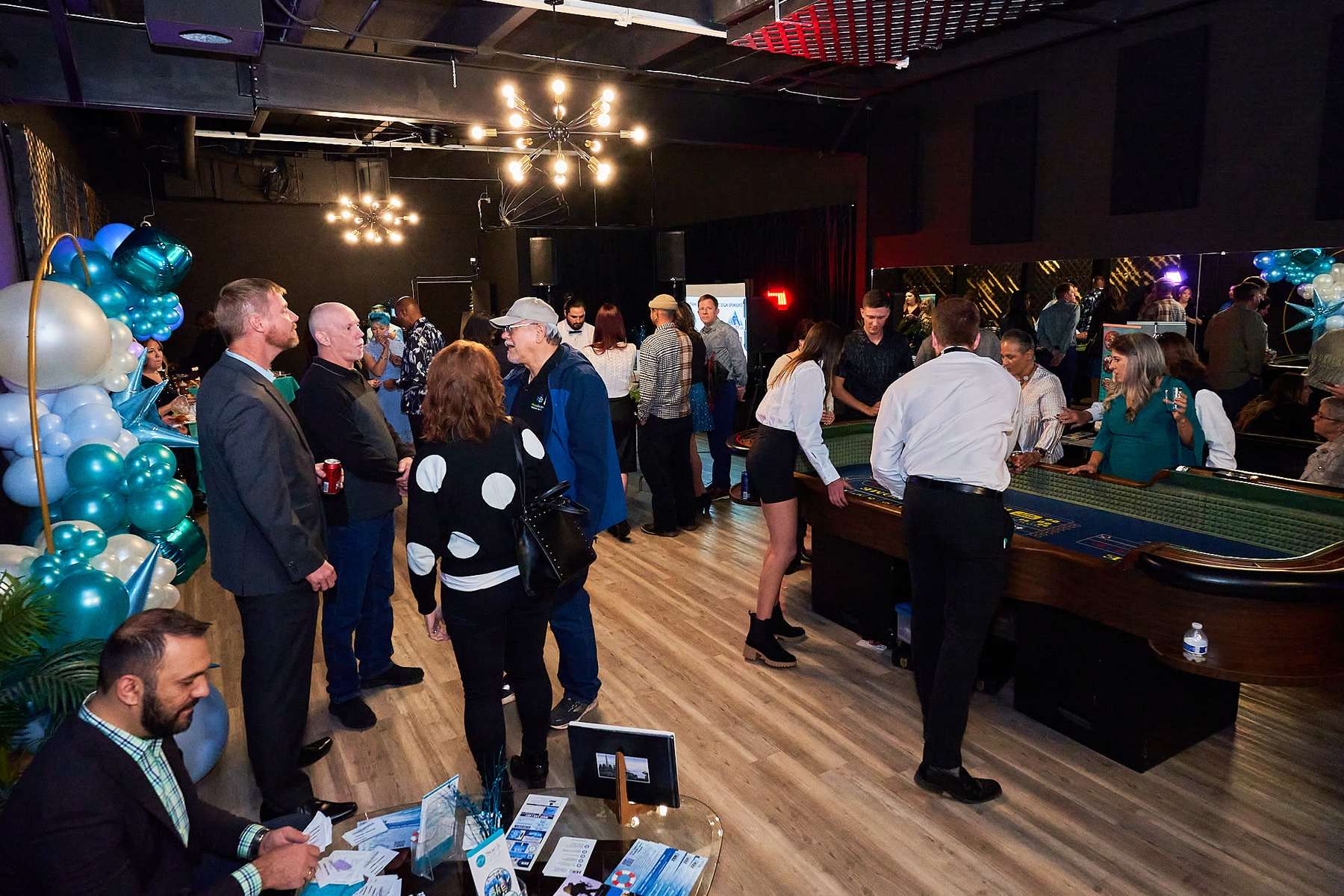 Colorado event with attendees mingling near ping-pong and balloon decor