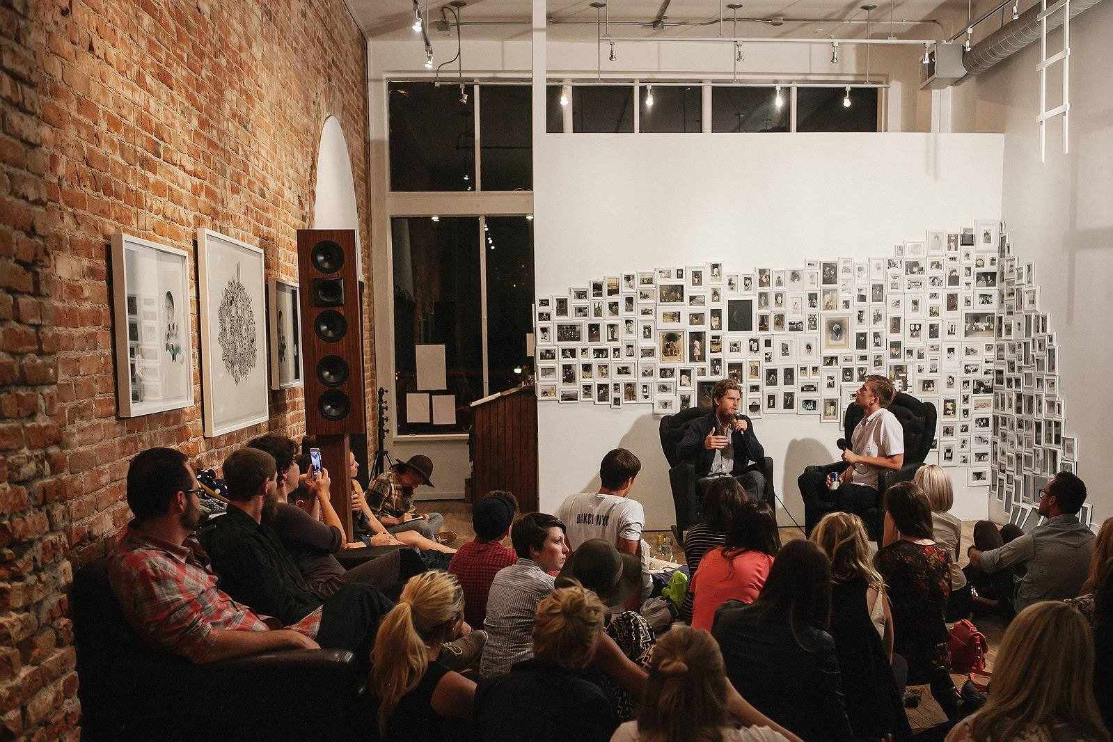 Audience gathered at a Denver gallery-style event experience