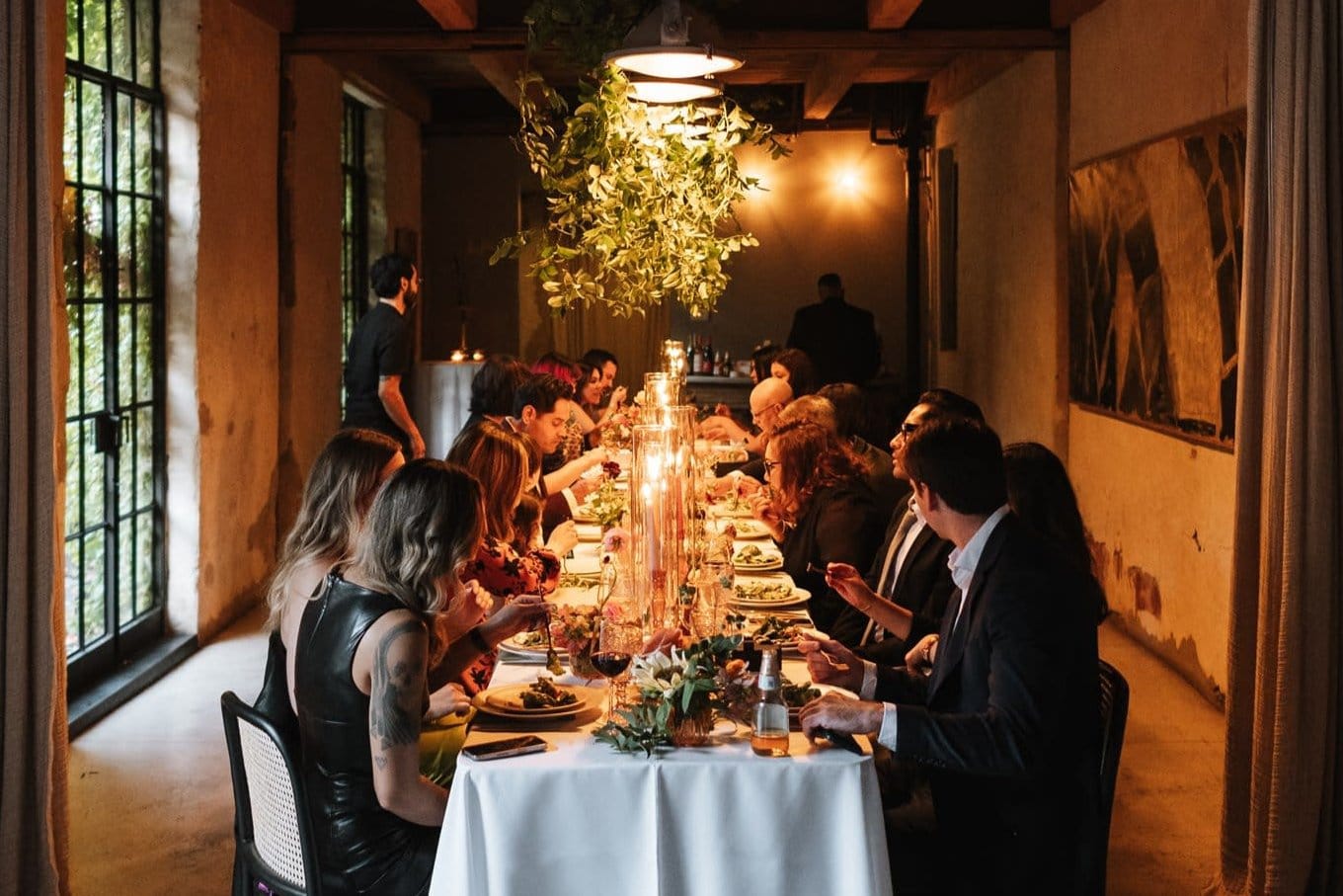 Curated Gold Coast dinner event with candles, formal styling, and guests