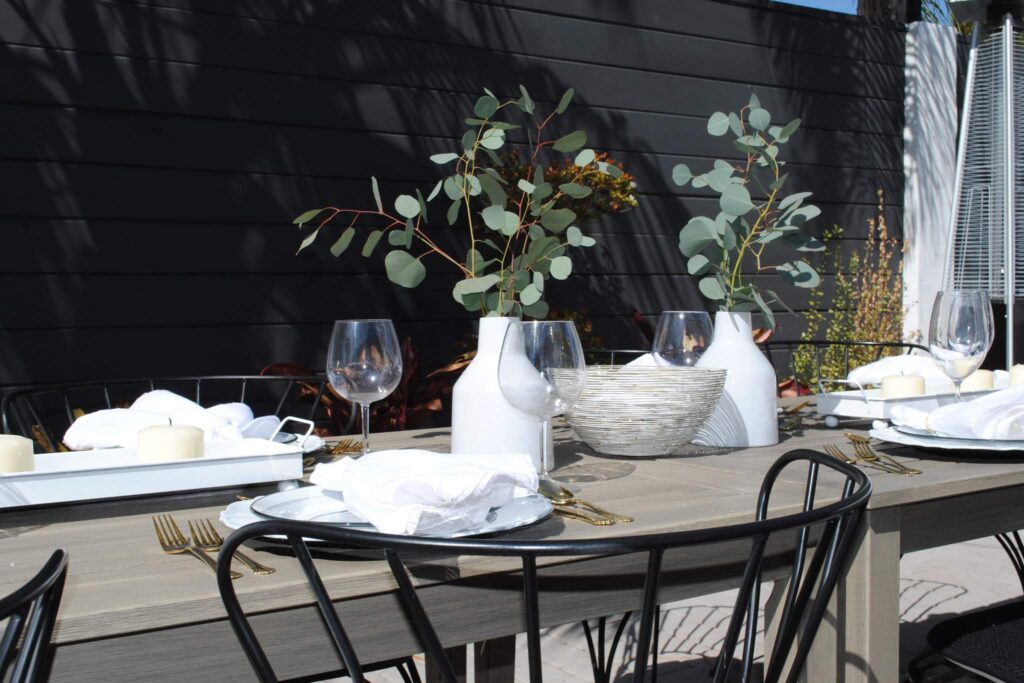Table setup with vases, glasses, and dishes designed by Los Angeles event planner