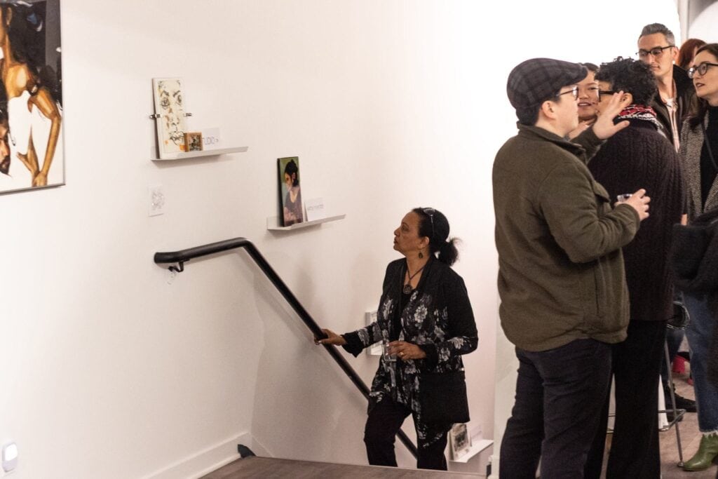 Guests walking through indoor art gallery venue for event designed by planner in Los Angeles