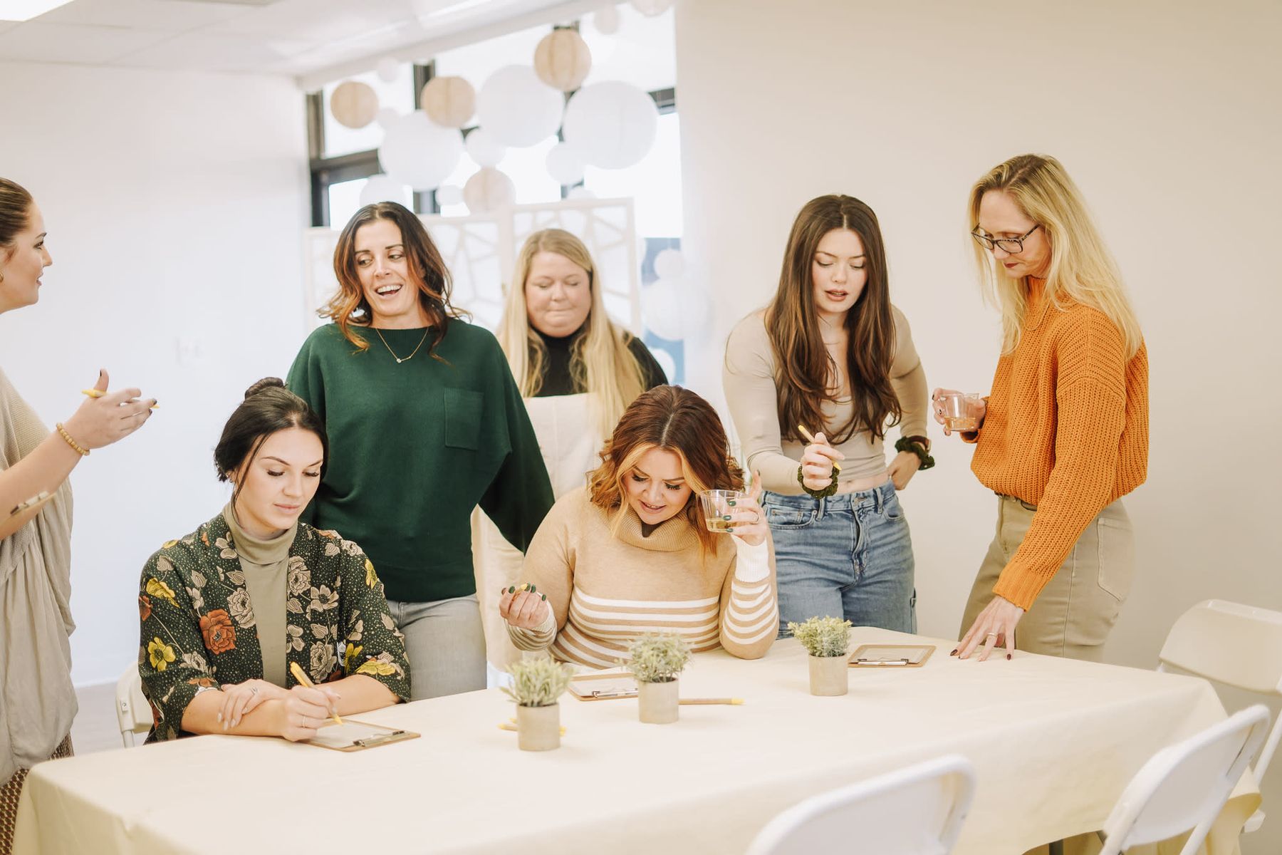 Women gathering around a decorated table at an intimate Memphis celebration
