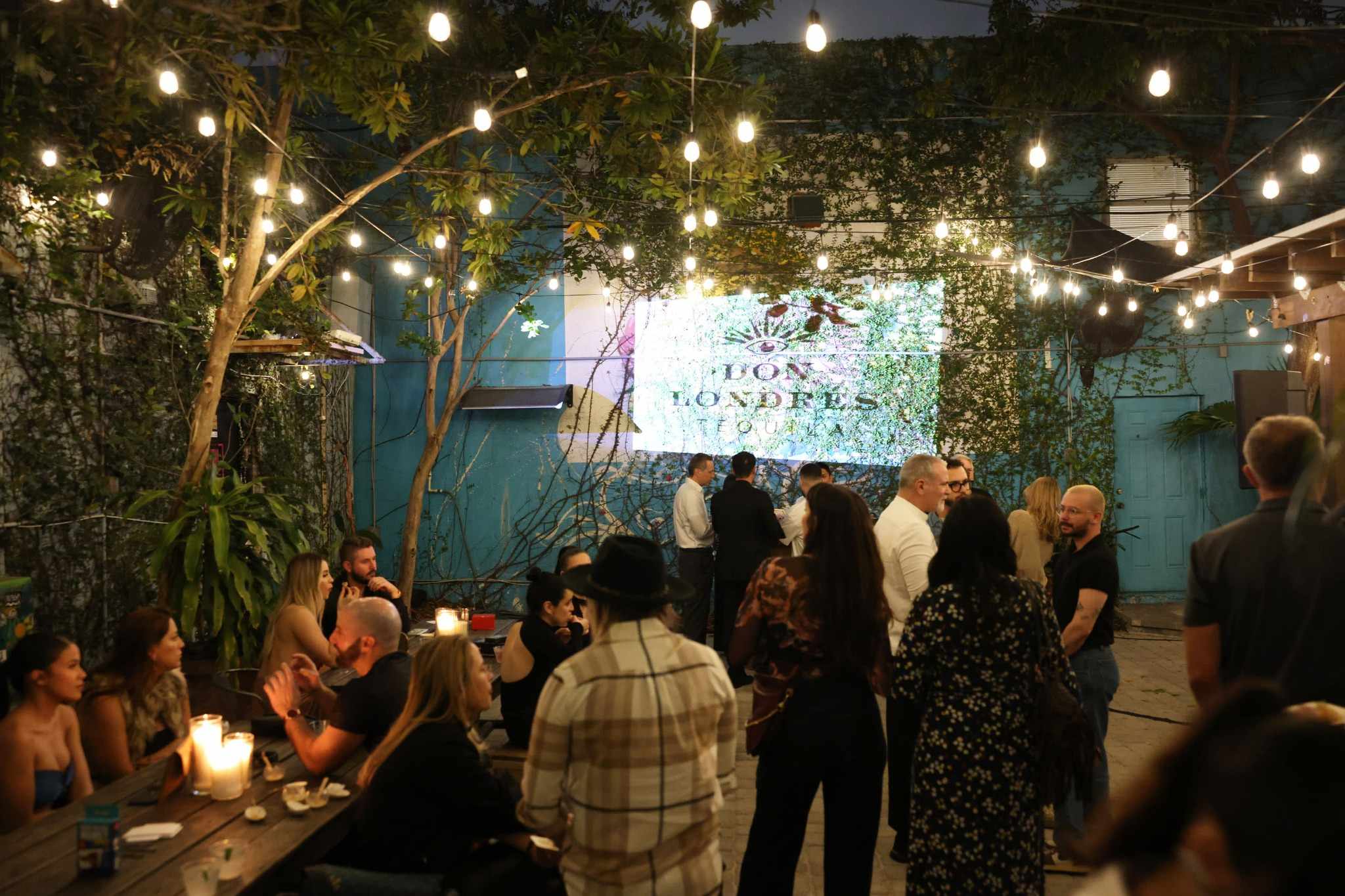 Sophisticated Miami evening event with greenery and guest mingling