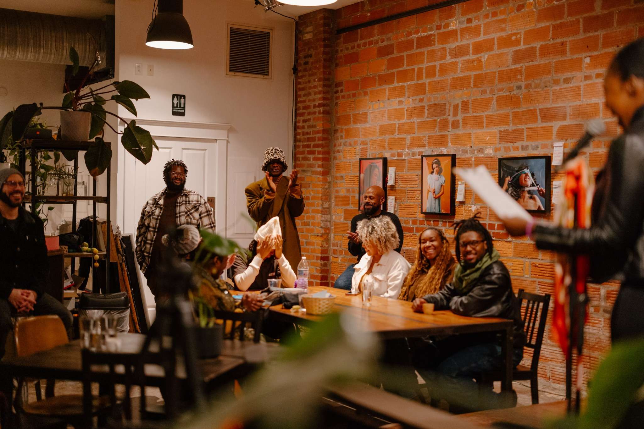 Attendees gathered around a communal table at a New Orleans loft event
