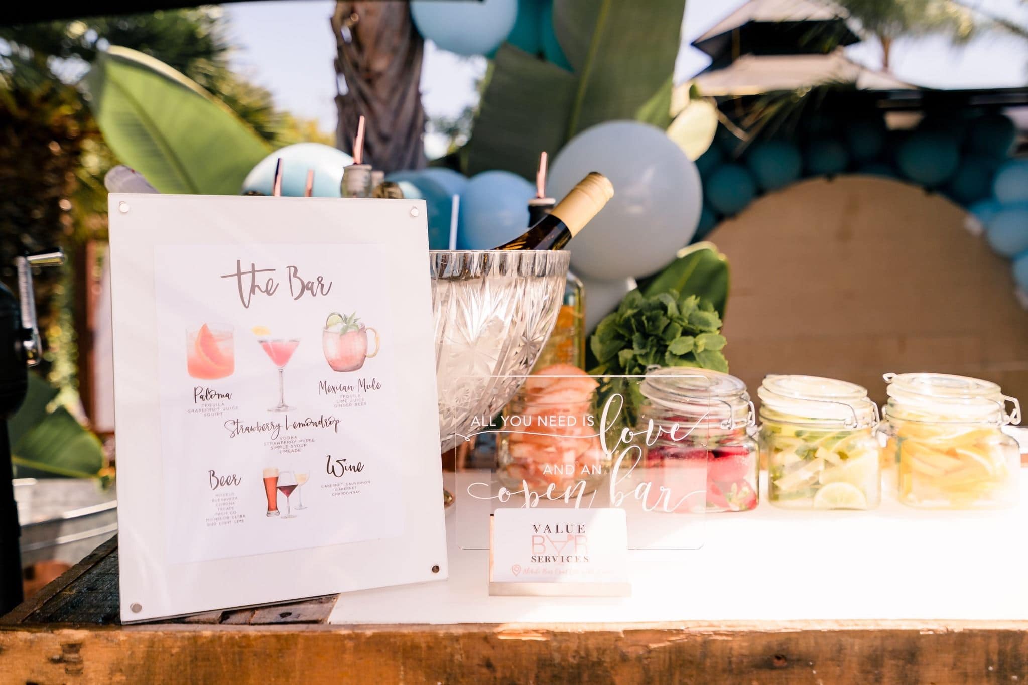 Styled Orlando event bar display with cocktail signage and beverages