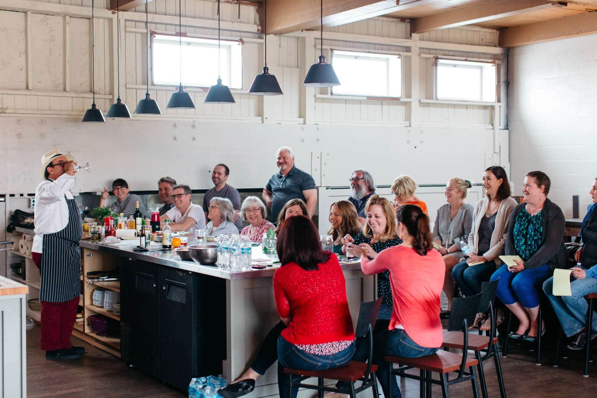Seattle culinary demonstration event with chef presenting to engaged attendees