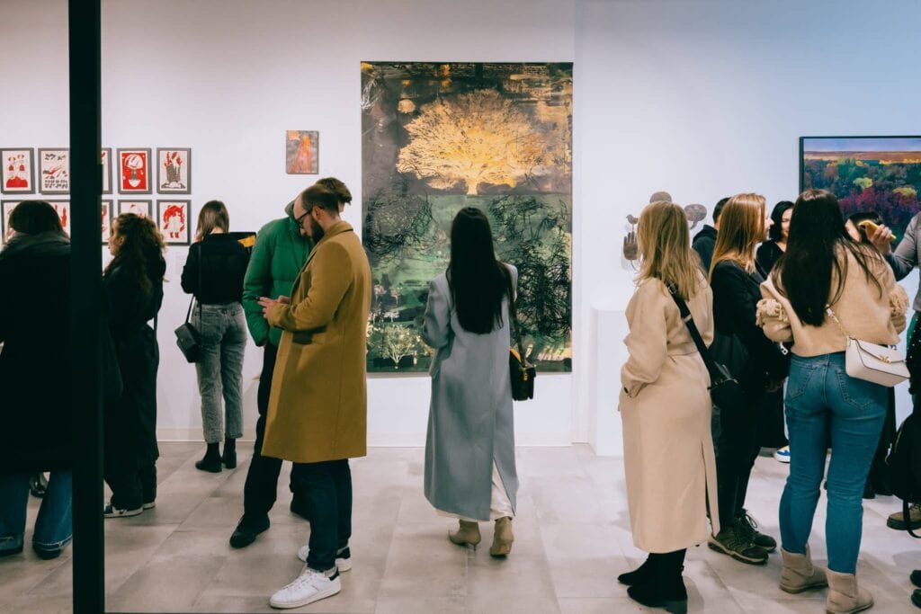 People walking through art gallery at event by Virginia event planner