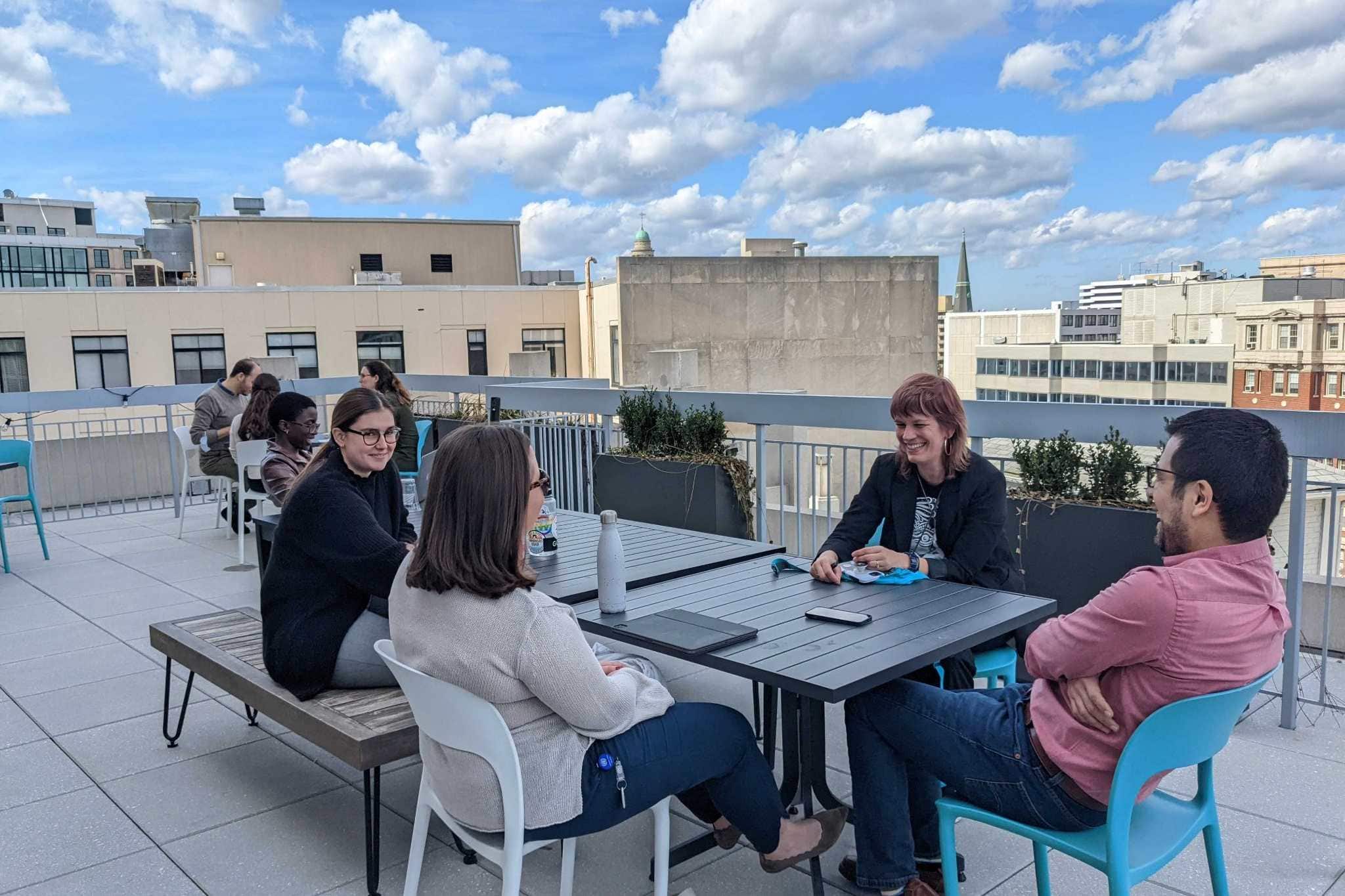 Rooftop gathering with urban Washington skyline and casual seating