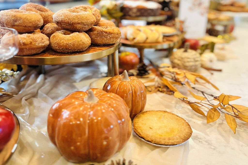 Donuts and other sweets sit on a fall-inspired table