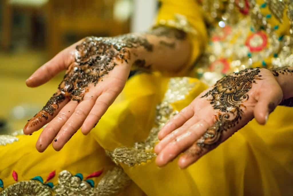 person's hands with henna menhdi tattoos
