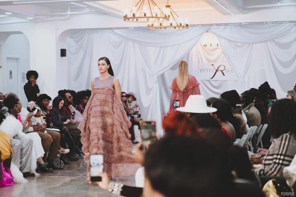 Models walk the runway at an intimate fashion show in NYC.