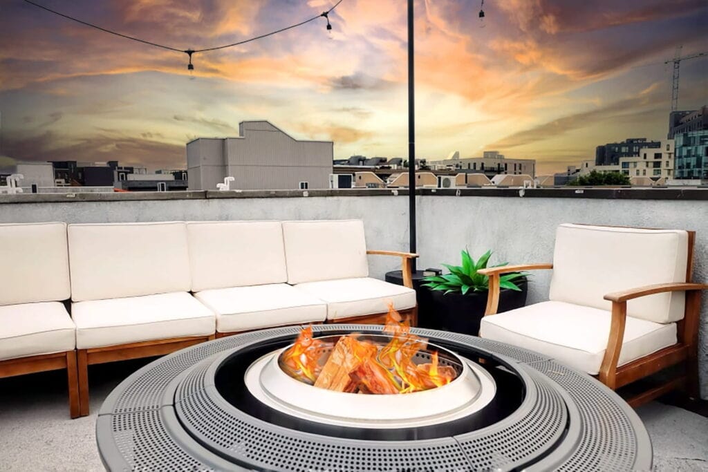 A fire is alight in a fire pit on a roof deck in Philadelphia