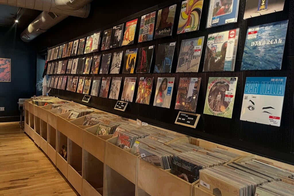 A wall of records is displayed at a record shop