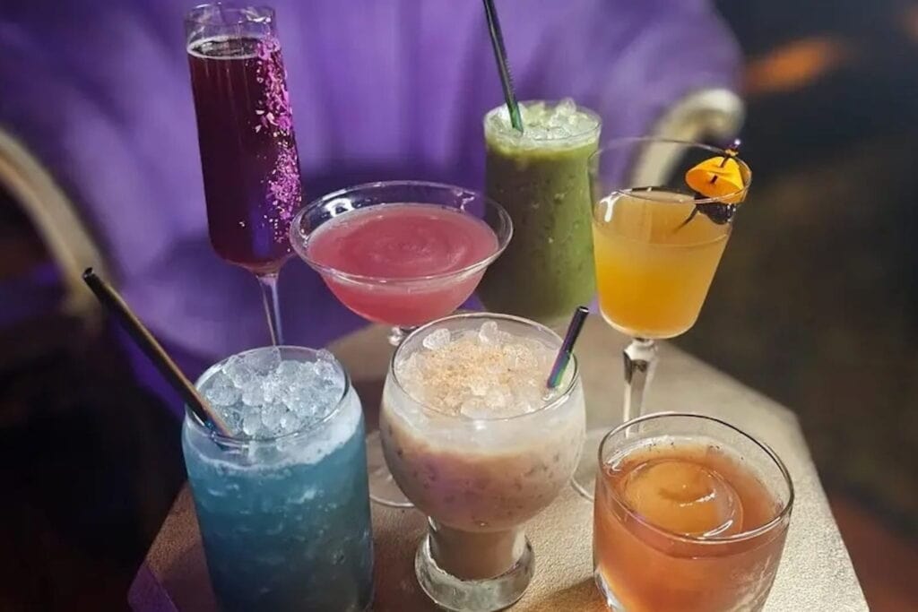 A selection of colorful drinks sit on a tray