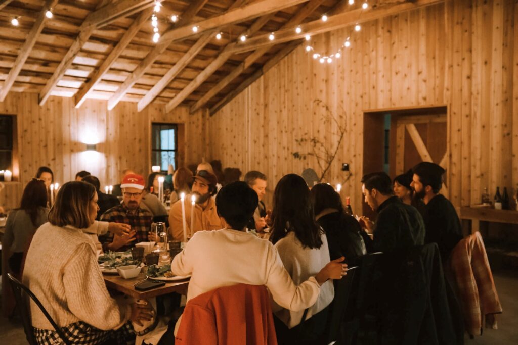 friends dining together in a rustic barn