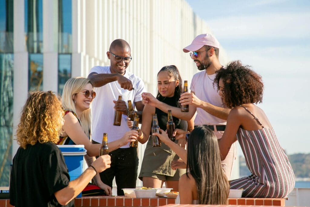 friends gathered around a cooler on beach